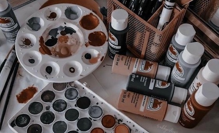 two paint palettes with assorted colours