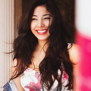 Brunette woman with her hair down in the breeze, laughing