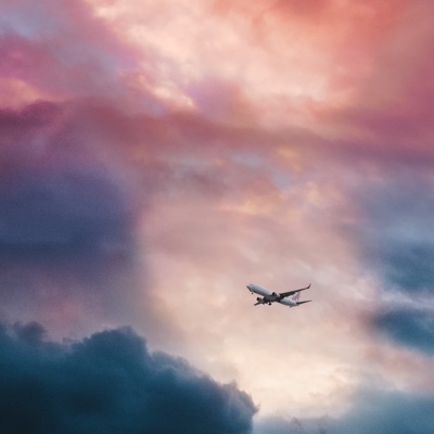 Plane in the sky during a sunset with clouds
